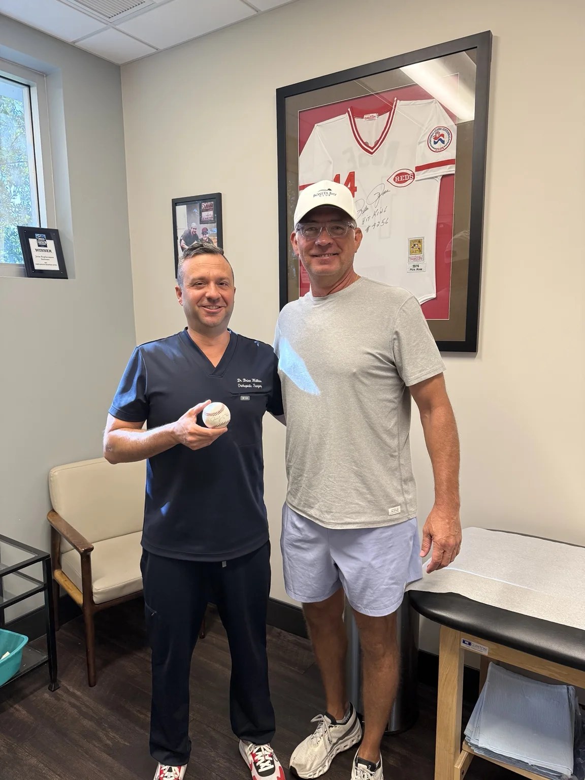 Dr. Brian Wallace in his orthopedic clinic with a baseball guest
